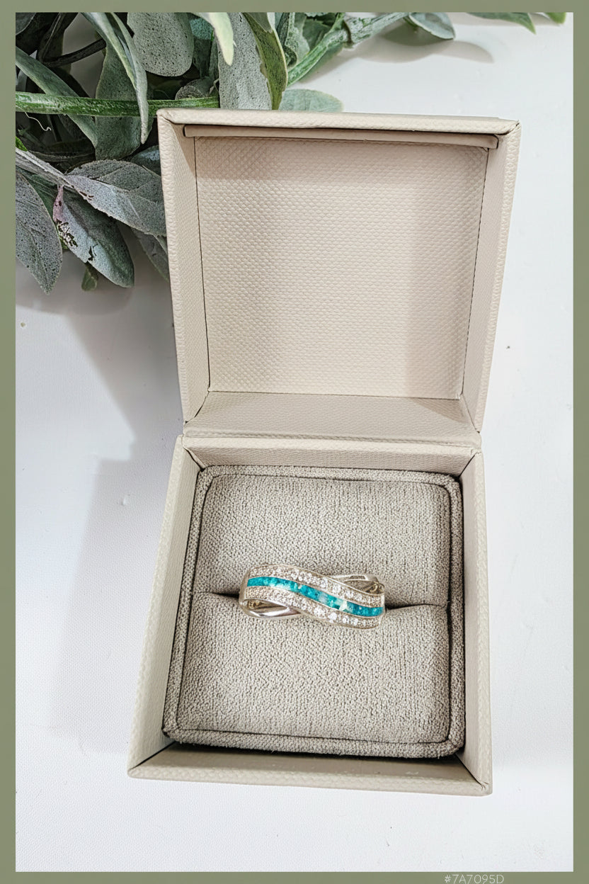 Silver memorial ashes ring with a teal colour in a wave design. Handcrafted memorial jewellery uk.