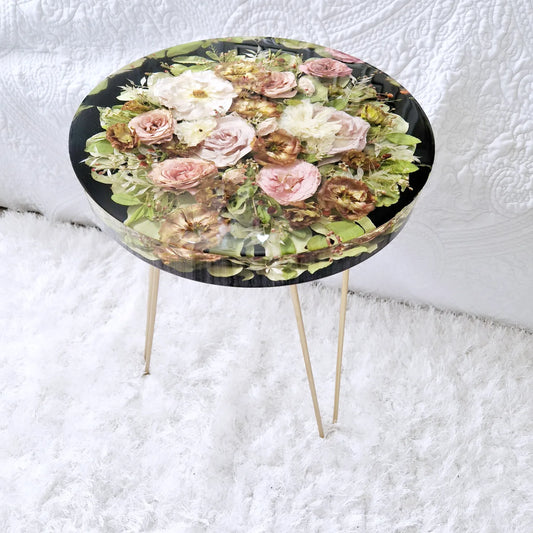 Custom round resin side table featuring preserved pink and coral wedding flowers sealed in crystal clear resin with gold metal legs