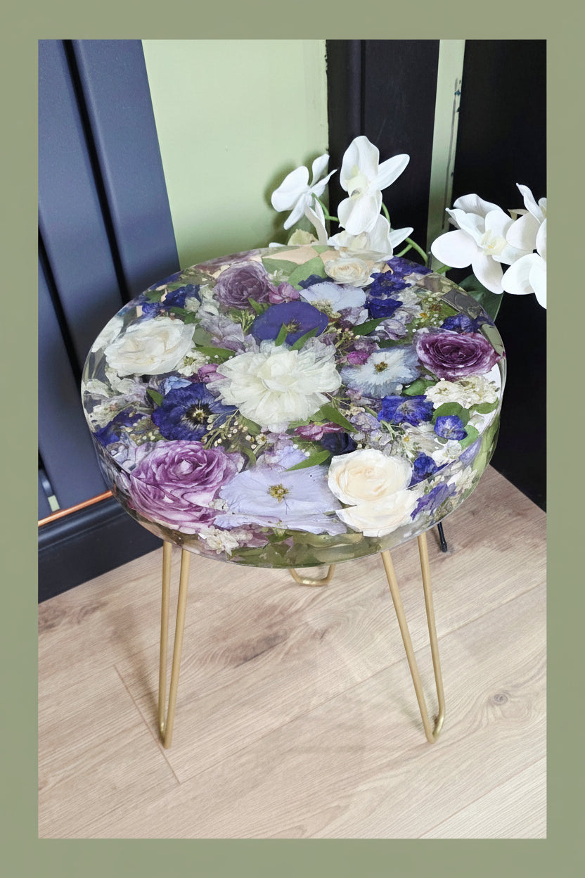 Bridal bouquet preservation side table featuring preserved wedding flowers in a clear resin, including white roses, purple roses and blue flowers, Uk flower preservation specialist.